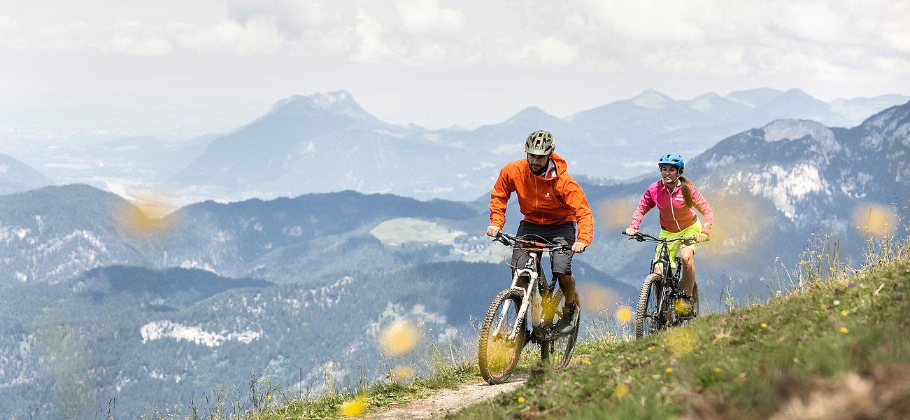 Two bikers on the mountain in summer