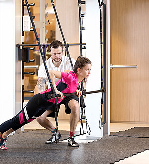 Trainer showing a guest a fitness exercise